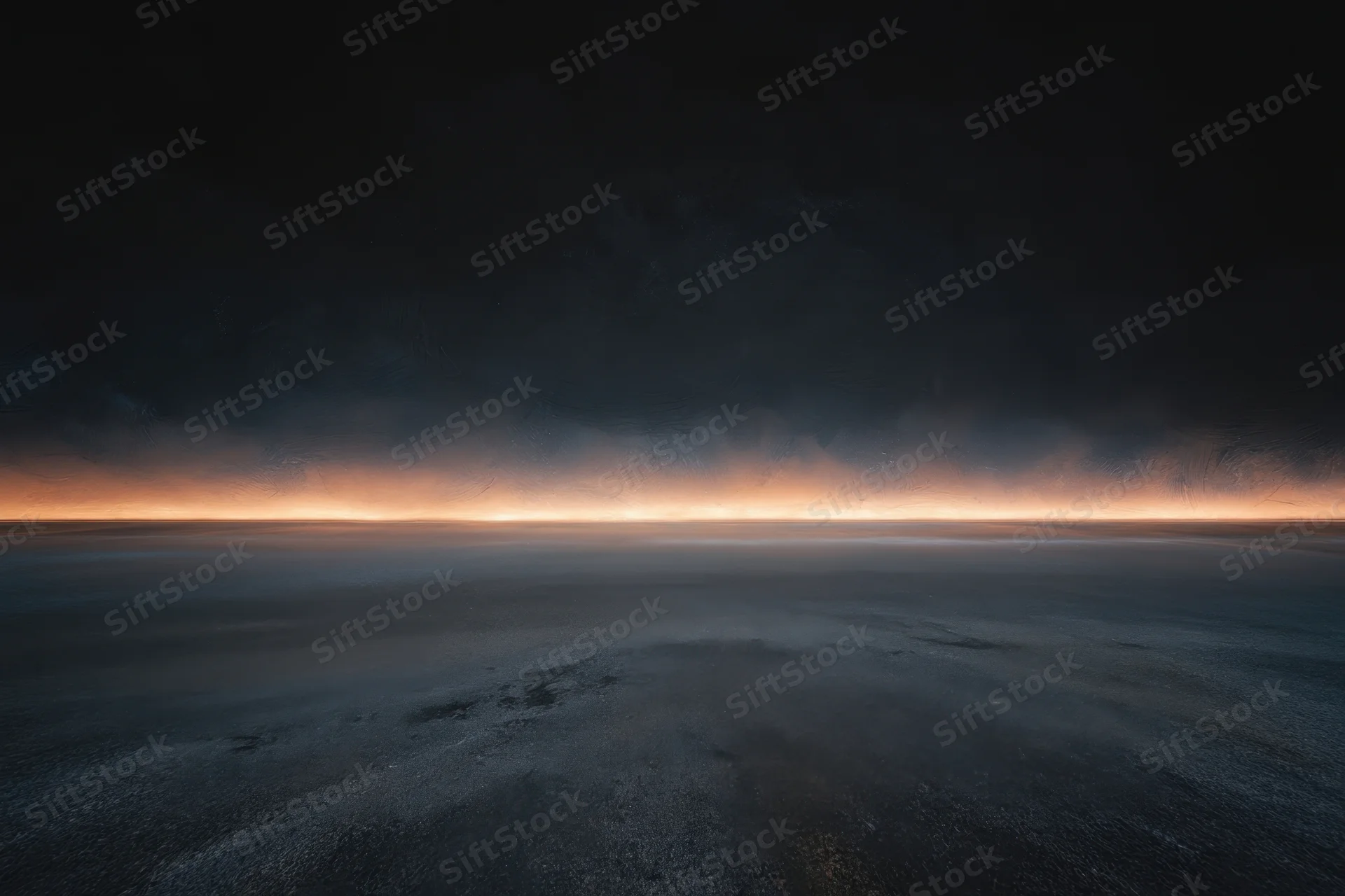 Dimly lit empty studio with textured charcoal wall and glowing horizon line