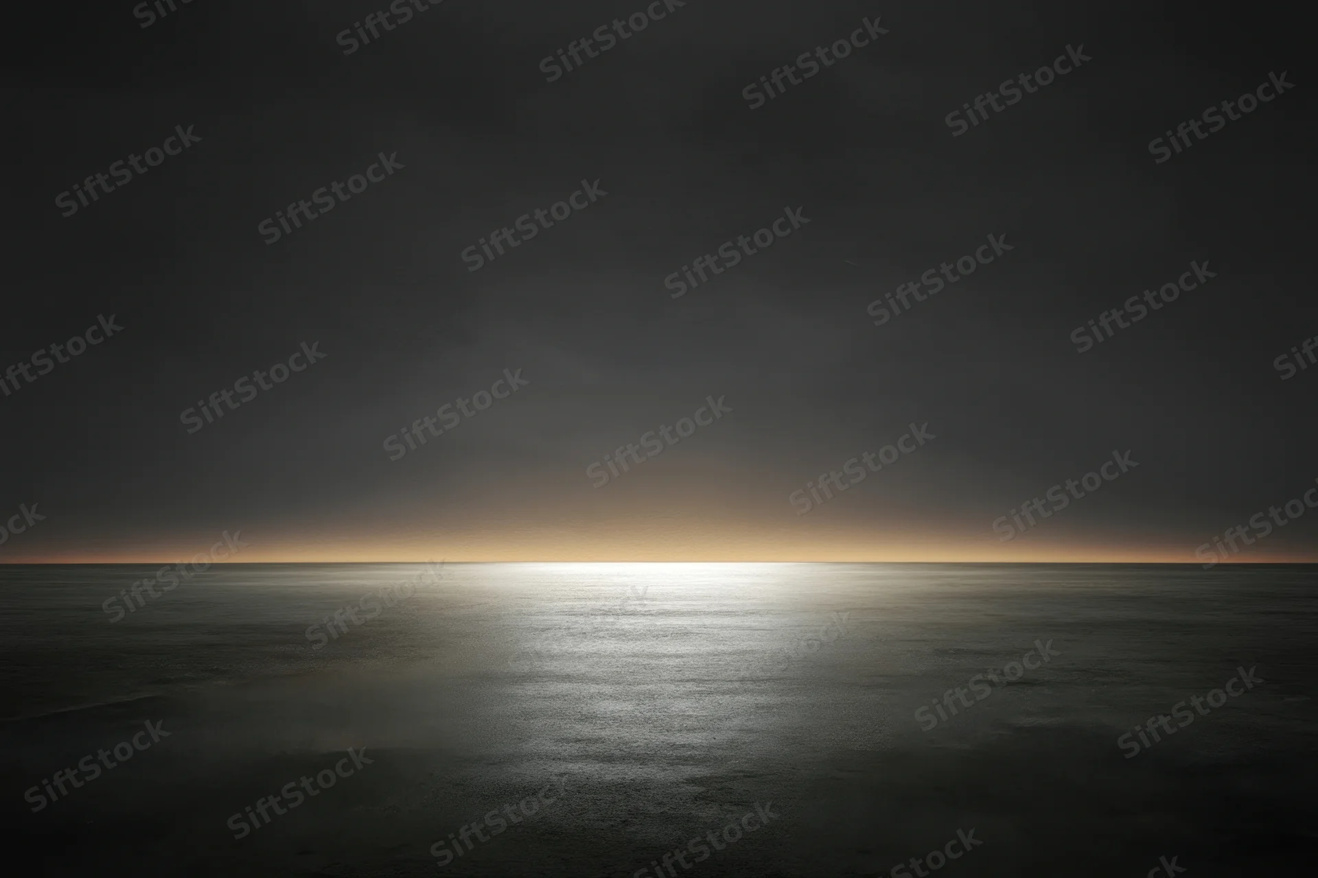 Calm ocean surface reflecting a glowing horizon at dusk under dark clouds