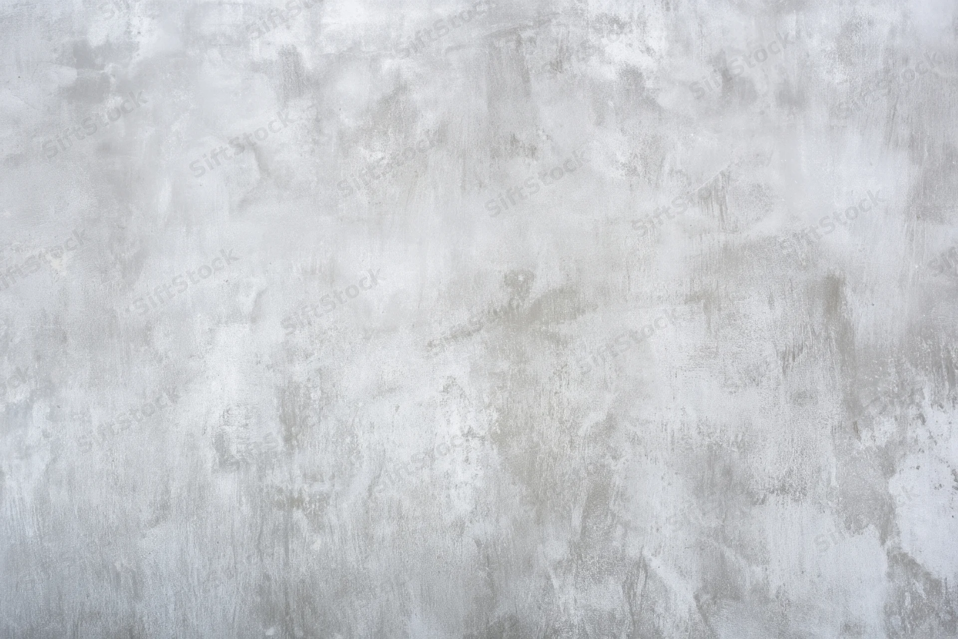 Weathered light gray concrete wall with rough texture and aged surface