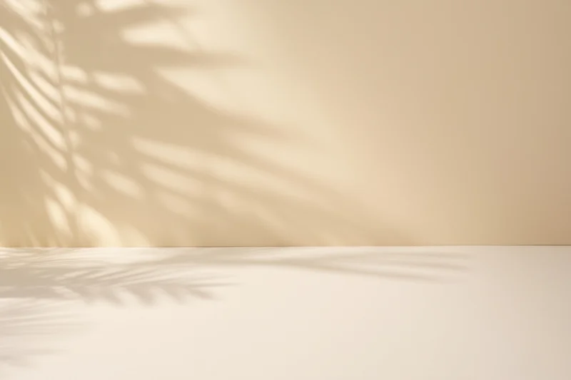 Minimalist interior with palm leaf shadows on beige wall and floor