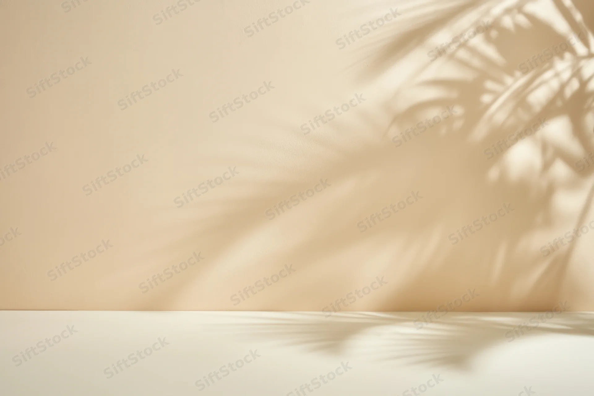 Minimalist interior with palm leaf shadows on beige wall and white surface
