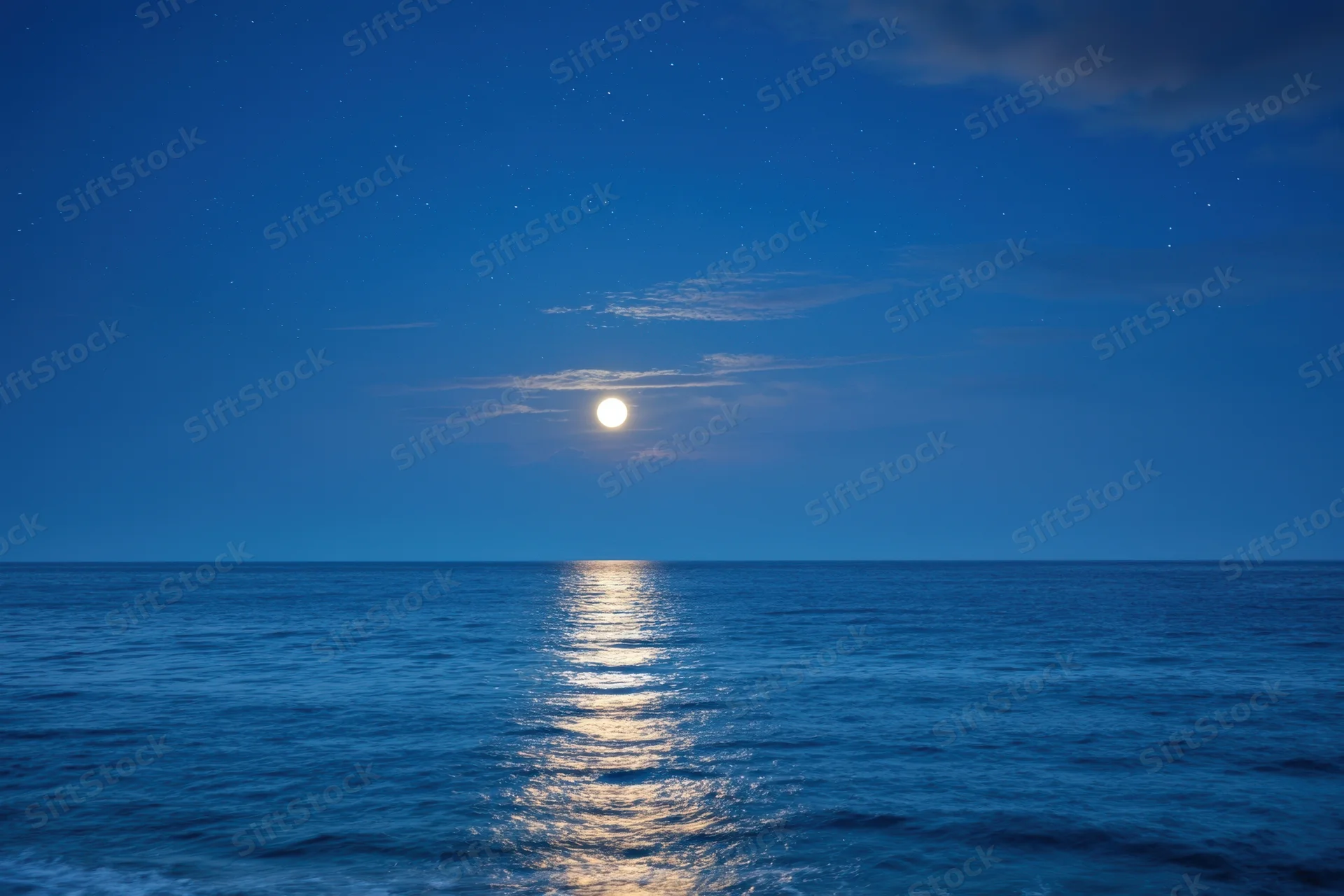 Full moon over calm ocean at night with starry sky and moonlight reflection on water surface