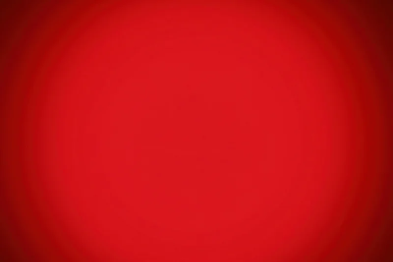 Smooth crimson red gradient background with radial vignette effect