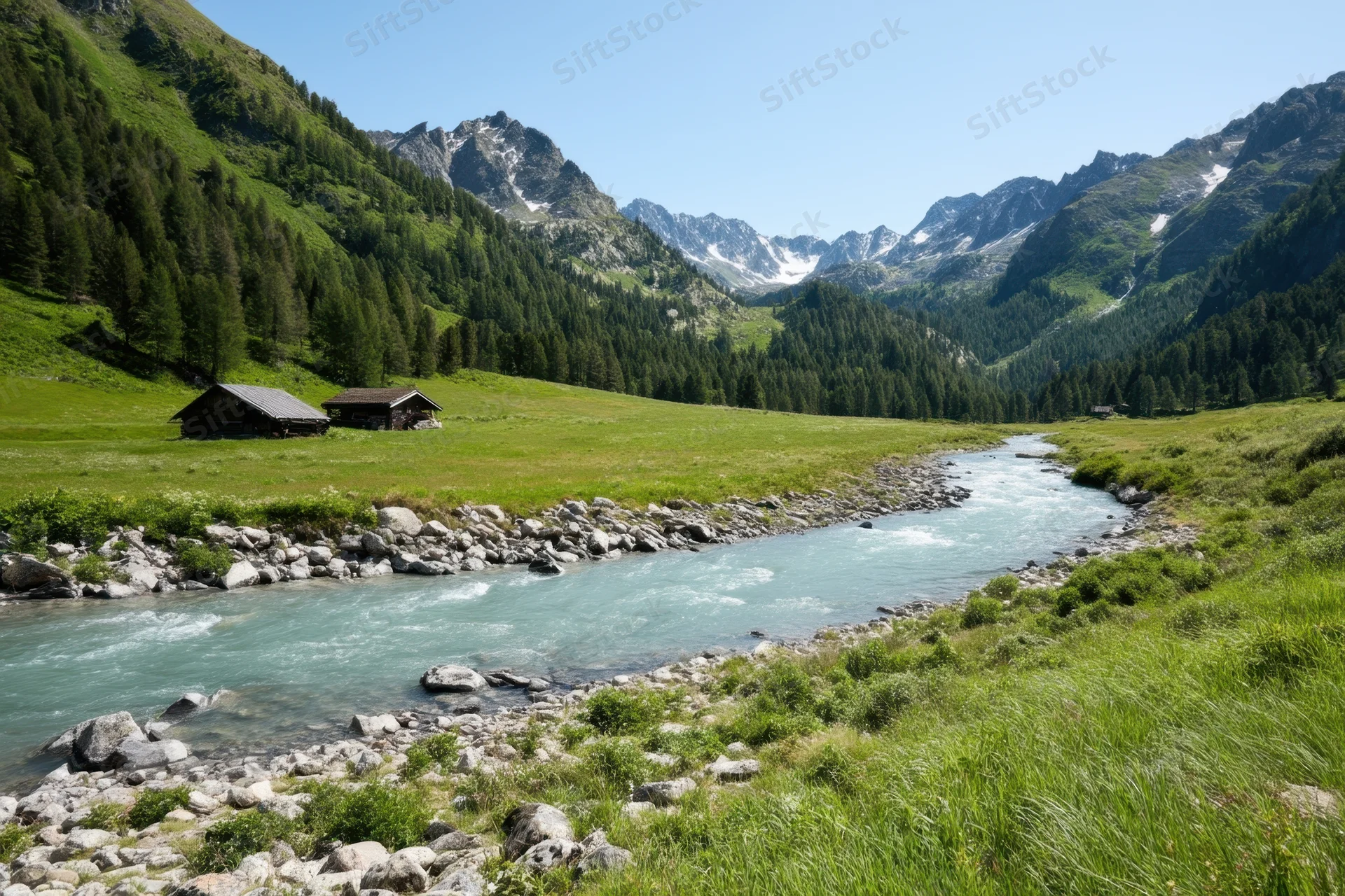 Turquoise river flowing through alpine valley with green meadows and rocky mountains in background
