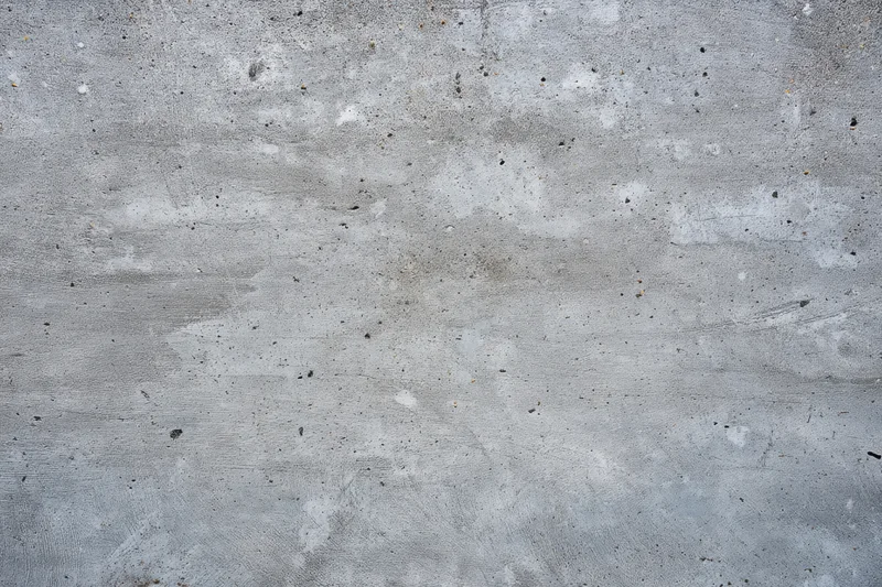 Weathered concrete surface with gray tones and rough texture showing signs of aging and wear