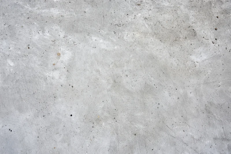 Weathered concrete surface with gray tones and speckled texture