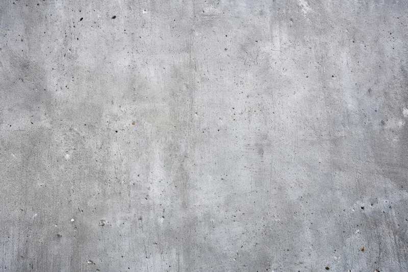 Weathered concrete wall surface with rough texture and gray tones
