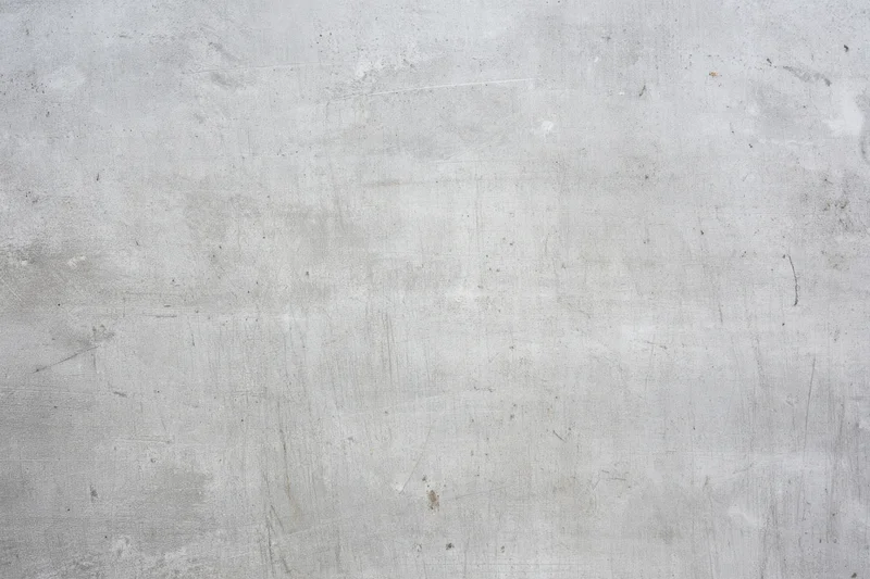 Weathered gray concrete wall with subtle scratches and marks