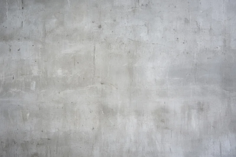Weathered gray concrete wall with subtle scratches and faint stains covering the entire frame