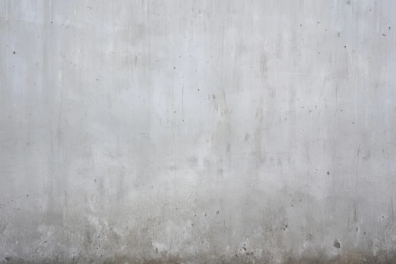 Weathered gray concrete wall with subtle scratches and stains