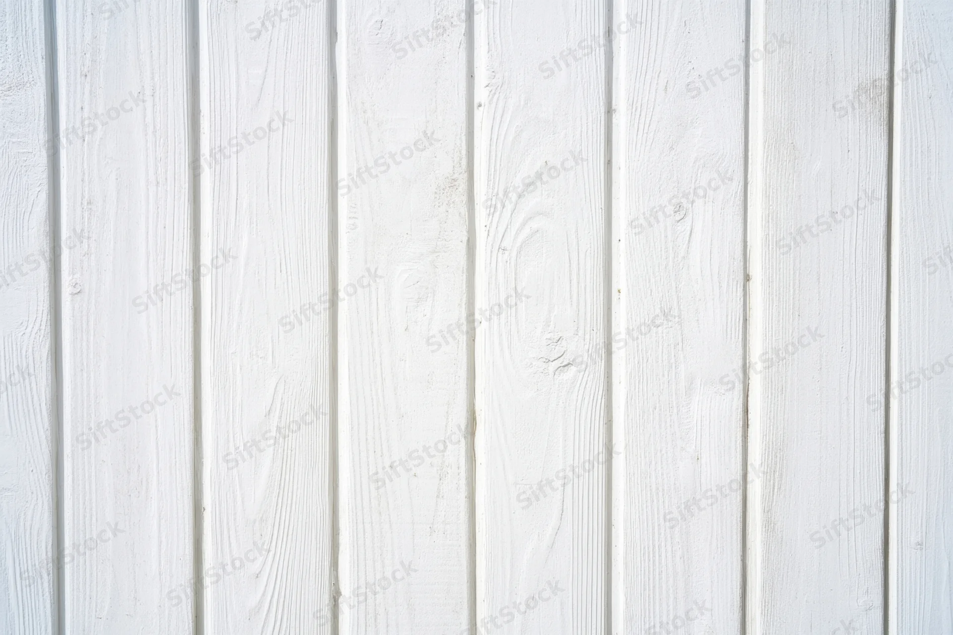 Whitewashed wooden plank wall with vertical boards and visible grain texture
