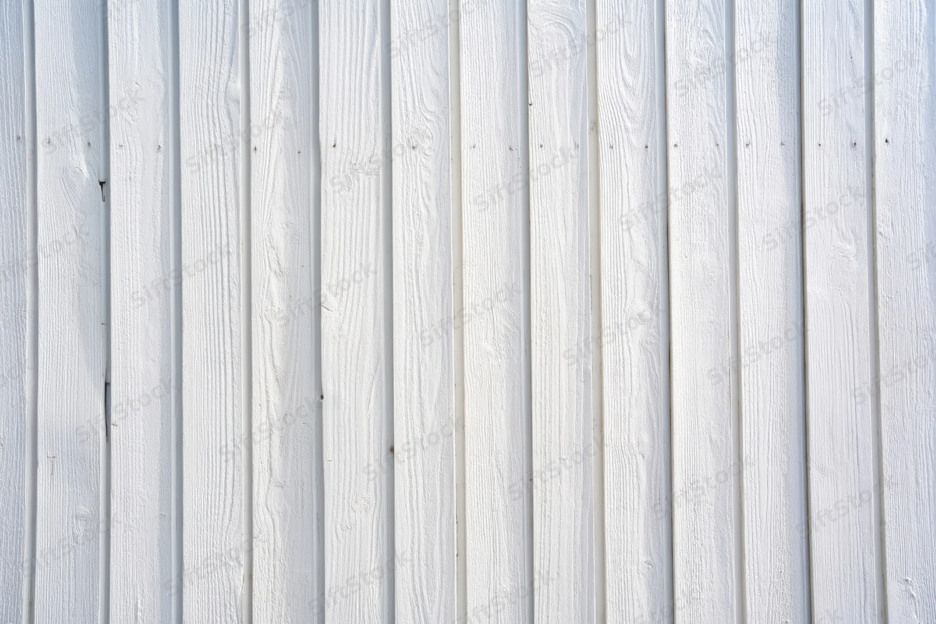 Vertical whitewashed wooden planks forming a textured wall surface