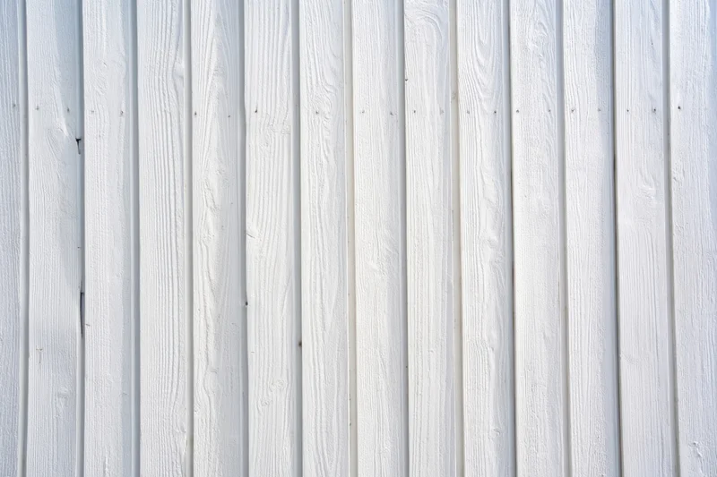 Vertical whitewashed wooden planks forming a textured wall surface