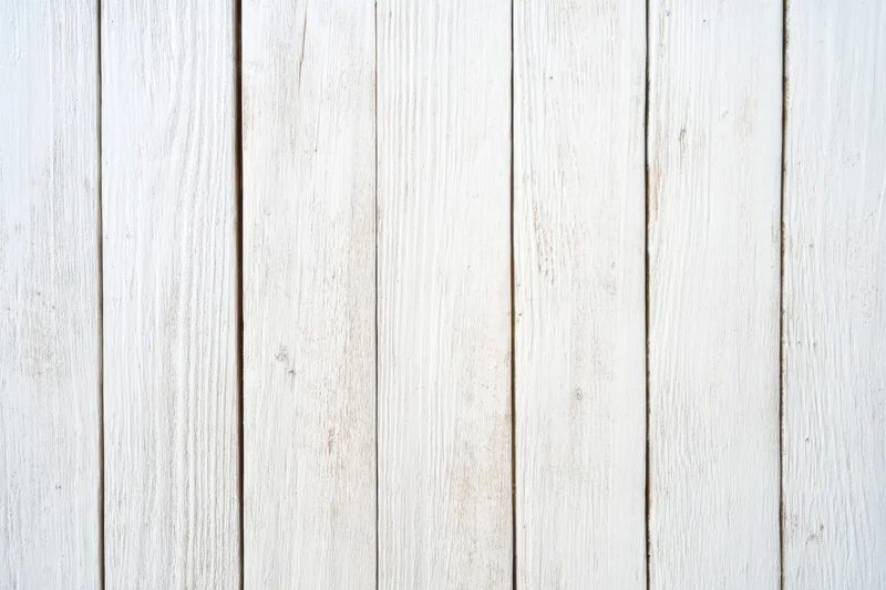 Whitewashed wooden planks arranged vertically as a textured wall surface