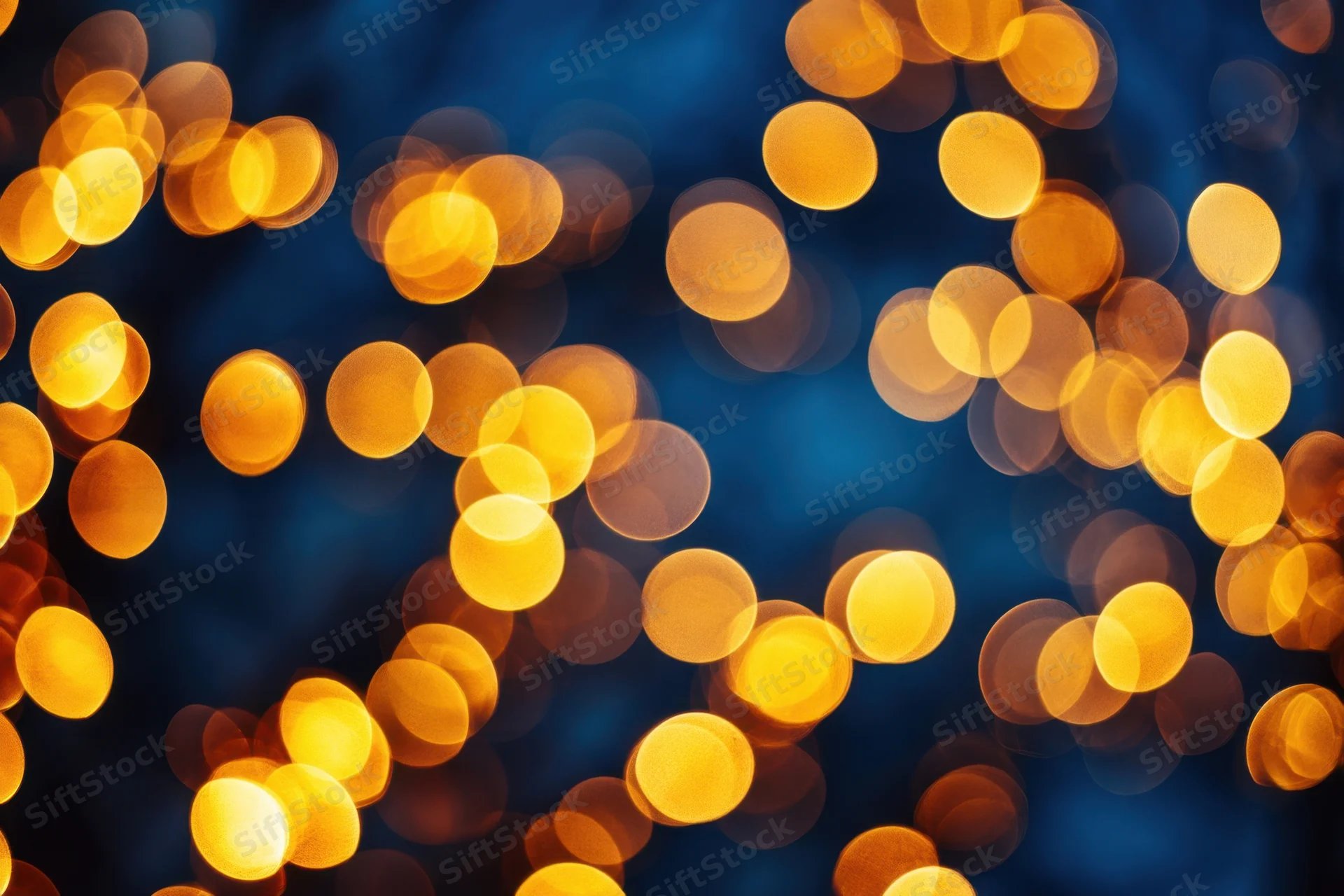 Warm golden bokeh lights scattered over a deep blue night background