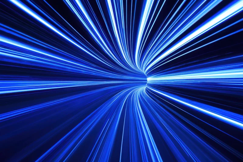 Blue neon light trails curving through a dark tunnel creating a sense of speed and motion