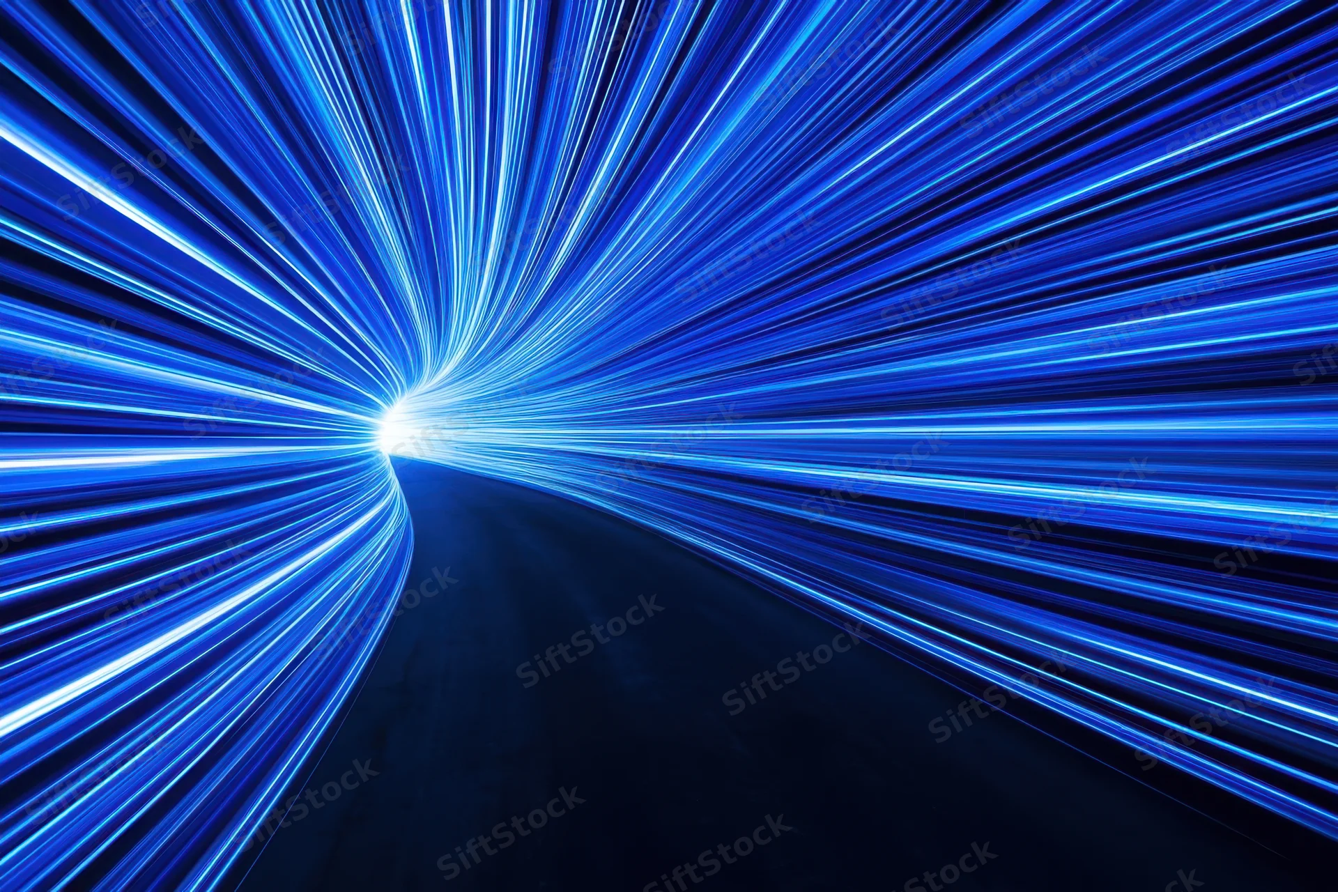 Curved tunnel of neon blue light trails moving through dark space