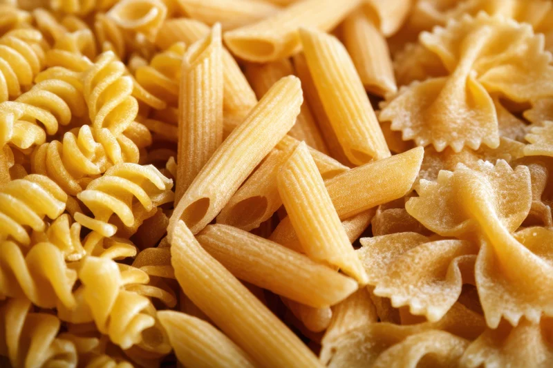 Close-up of fusilli, penne and farfalle dry pasta mixed together