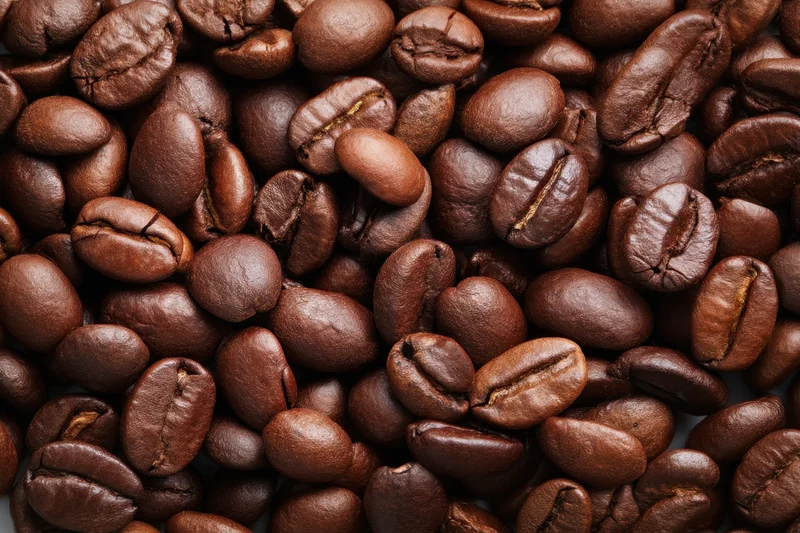 Roasted coffee beans filling the frame in closeup view