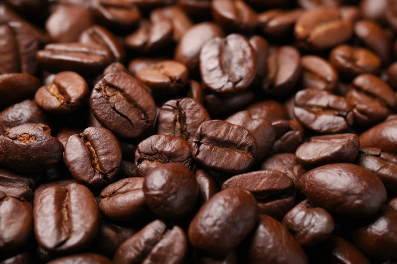 Roasted coffee beans filling the frame in a closeup view