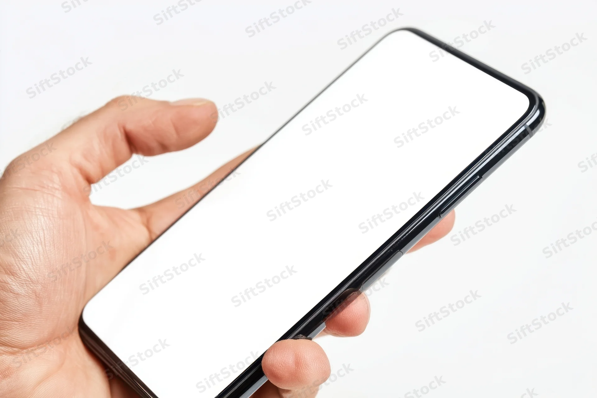 Hand holding a modern smartphone with blank white screen against white background