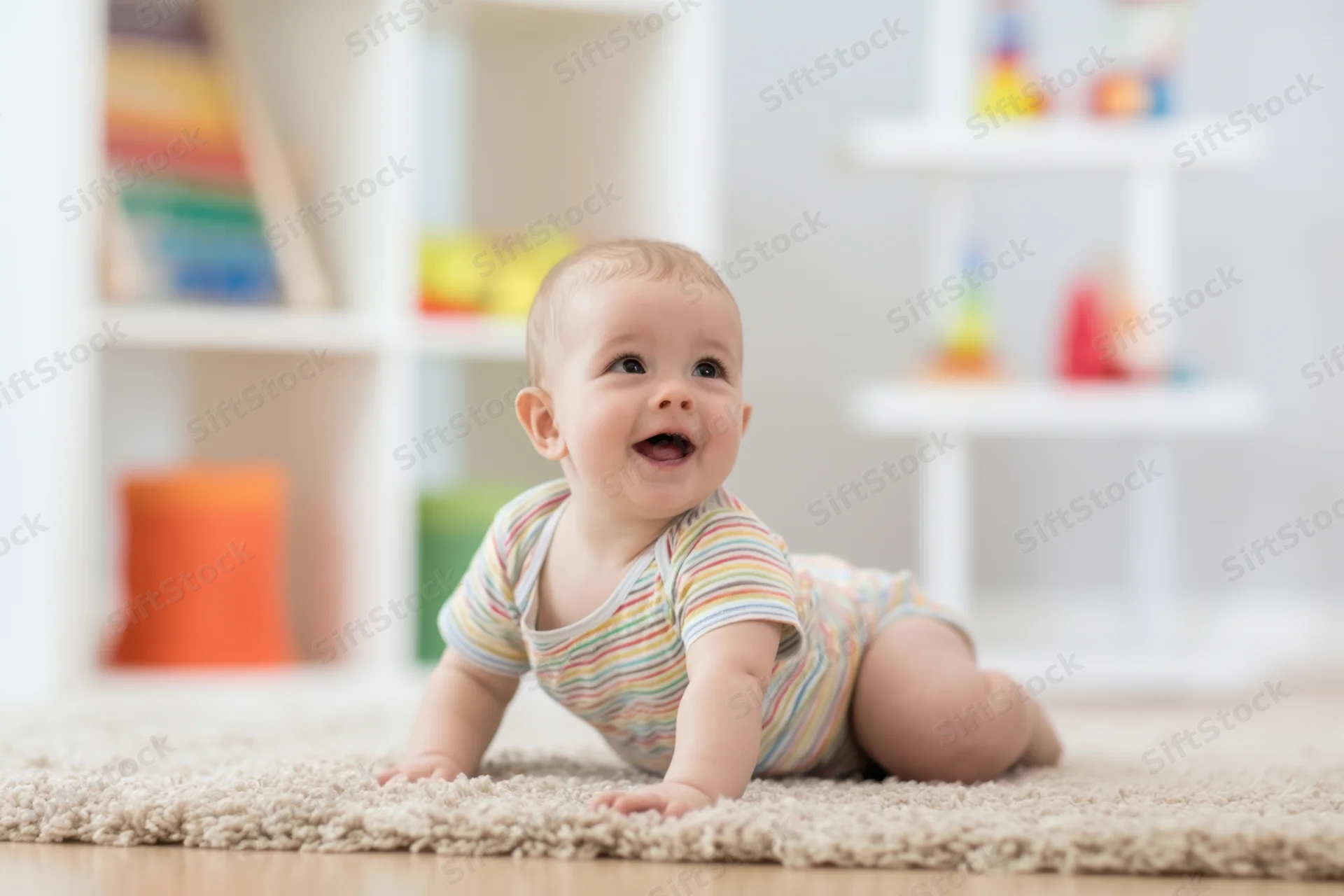 Baby crawling on soft beige rug in bright playroom with toys on shelves