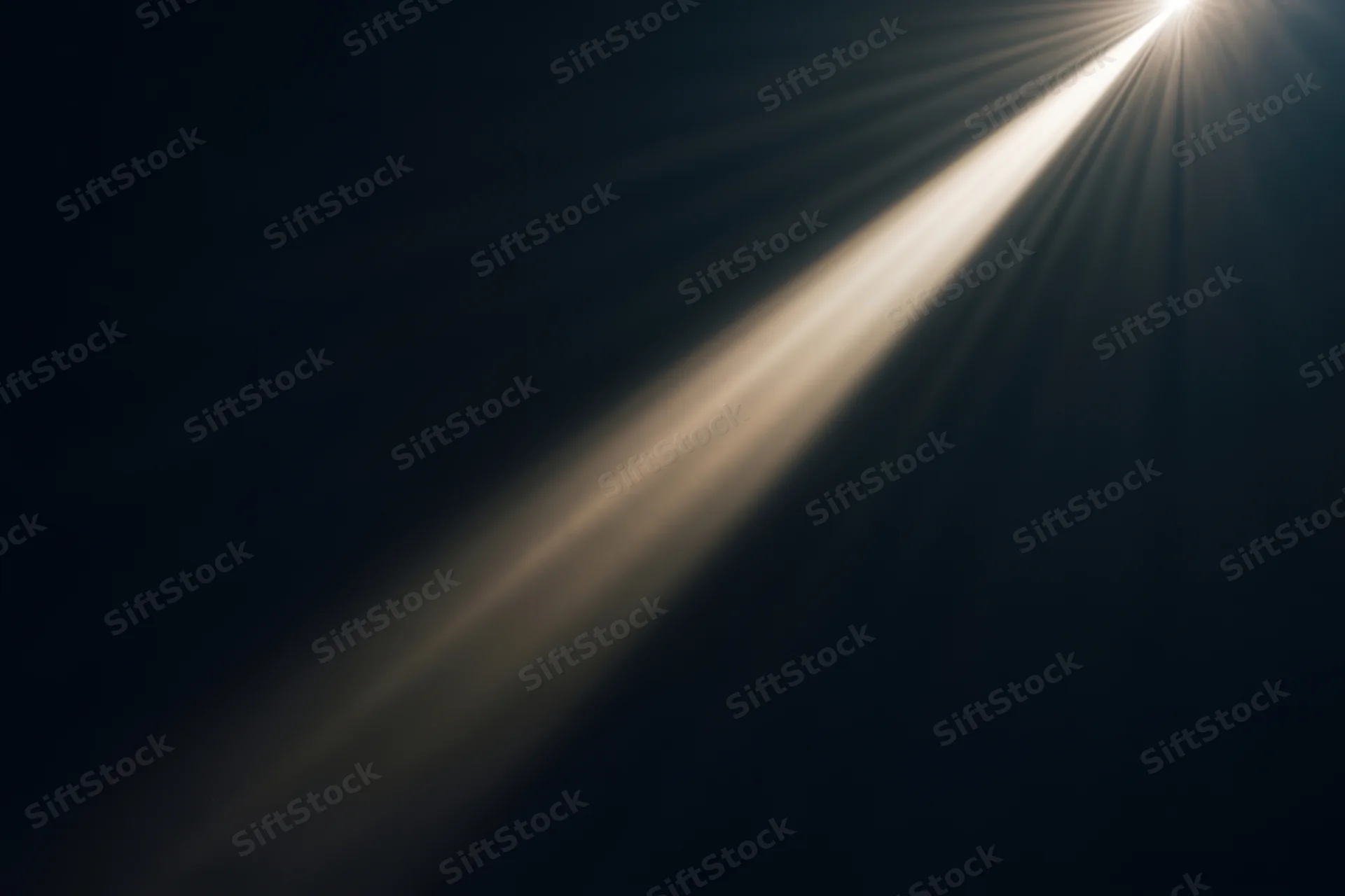 Diagonal beam of light cutting through dark void