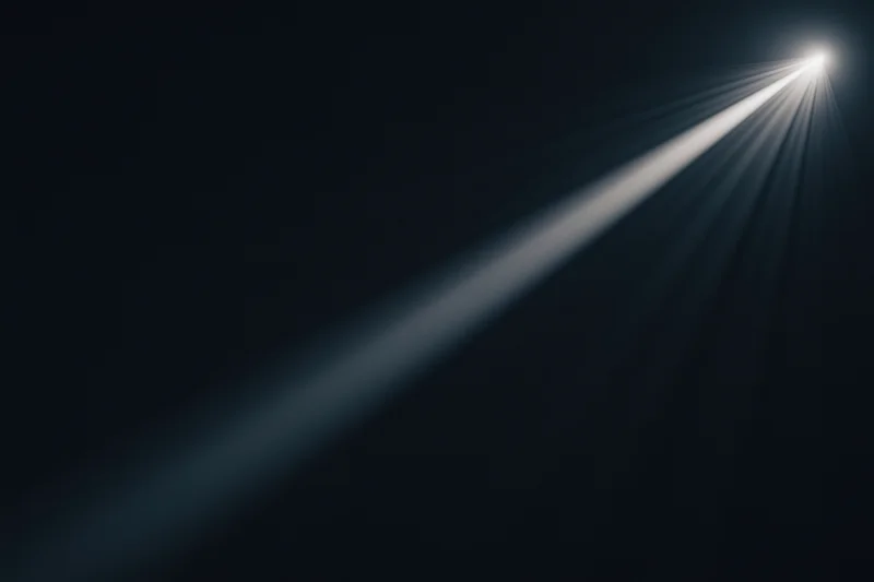 Diagonal beam of light cutting through dark void