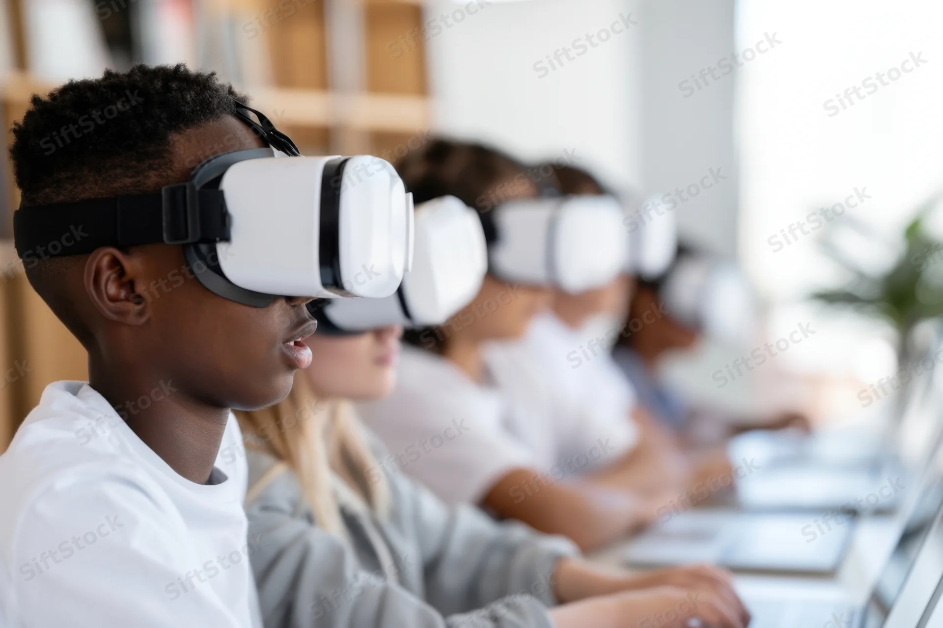 Children wearing vr headsets seated in a row at desks in a bright classroom
