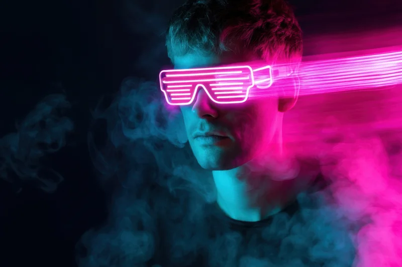 Man wearing glowing neon led sunglasses in a smoky dark environment