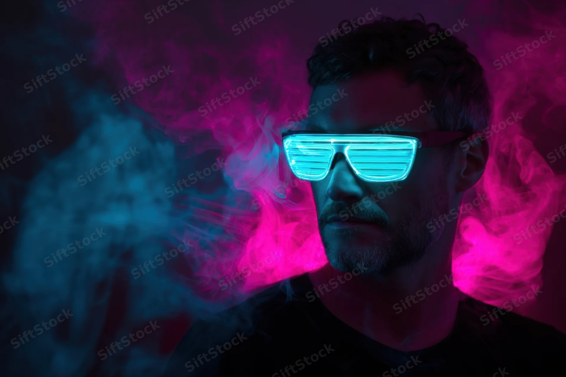 Man wearing glowing neon led sunglasses in dark smoky atmosphere