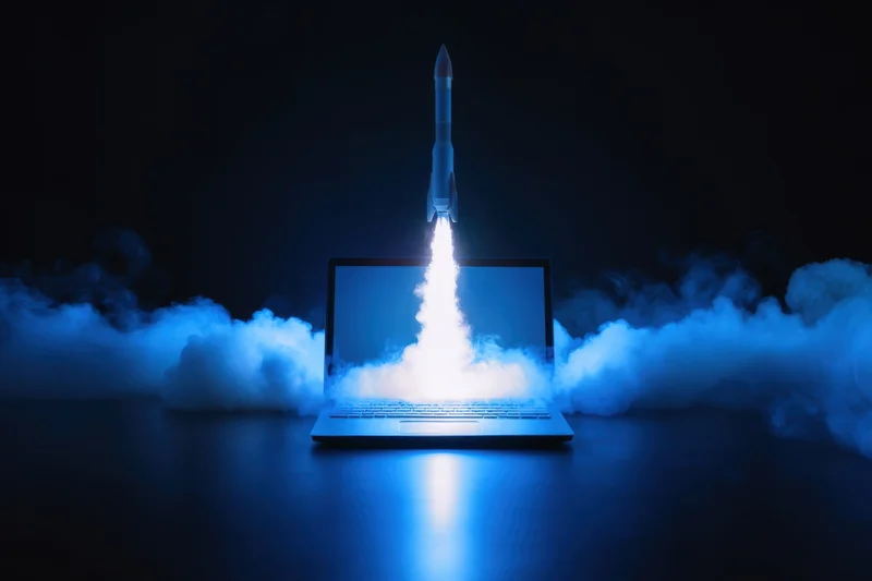 Rocket launching from laptop screen into smoke plume at night