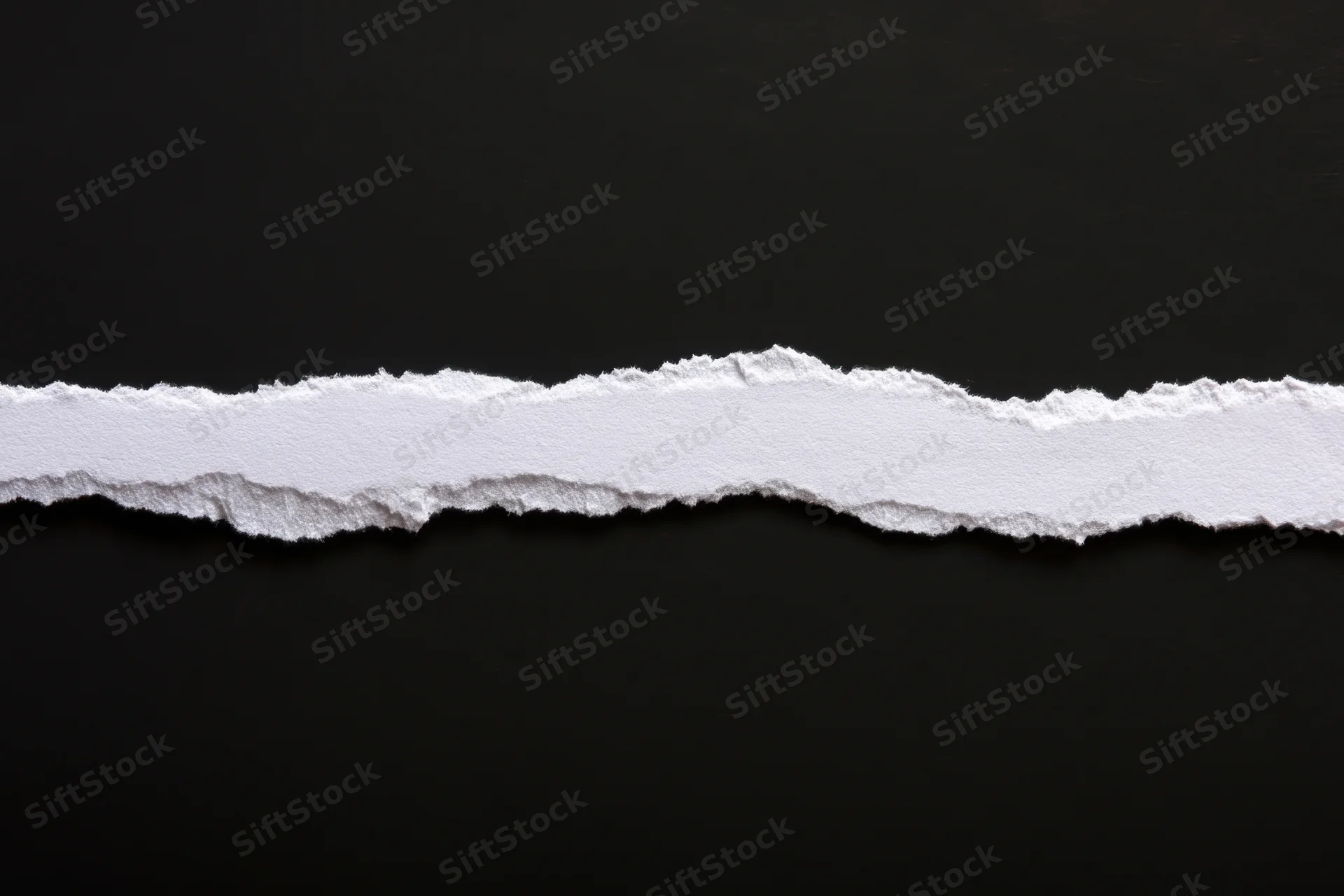 Horizontal torn white paper strip on black background