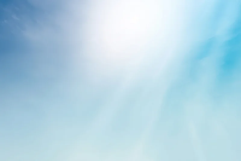 Soft blue gradient sky with gentle light and subtle clouds as a background