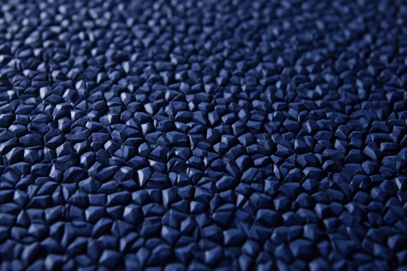 Close-up of dark blue hexagonal tessellated surface with geometric pattern