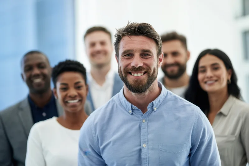 Diverse team of professionals smiling in a bright modern office