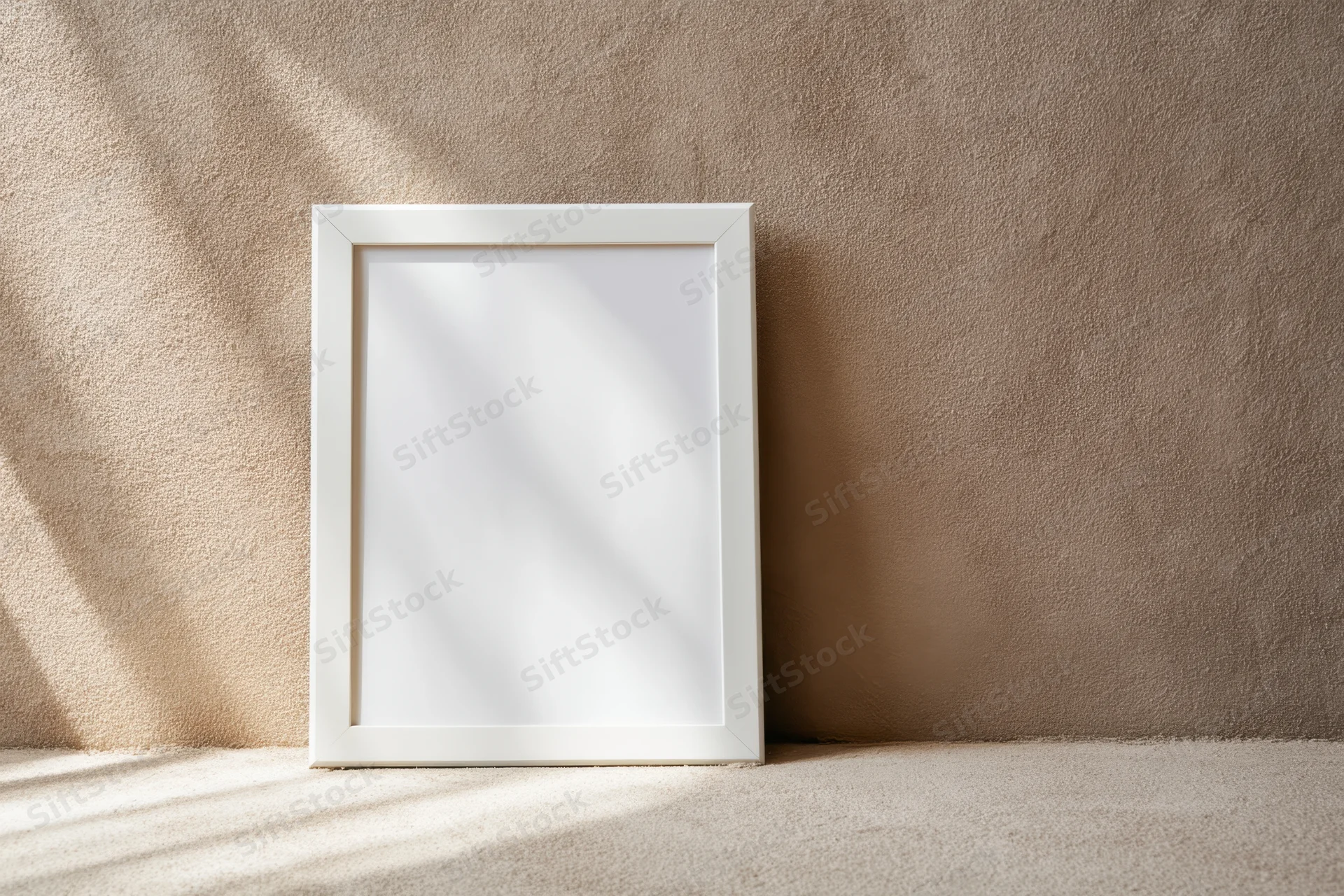 White frame leaning against textured taupe wall in minimalist interior