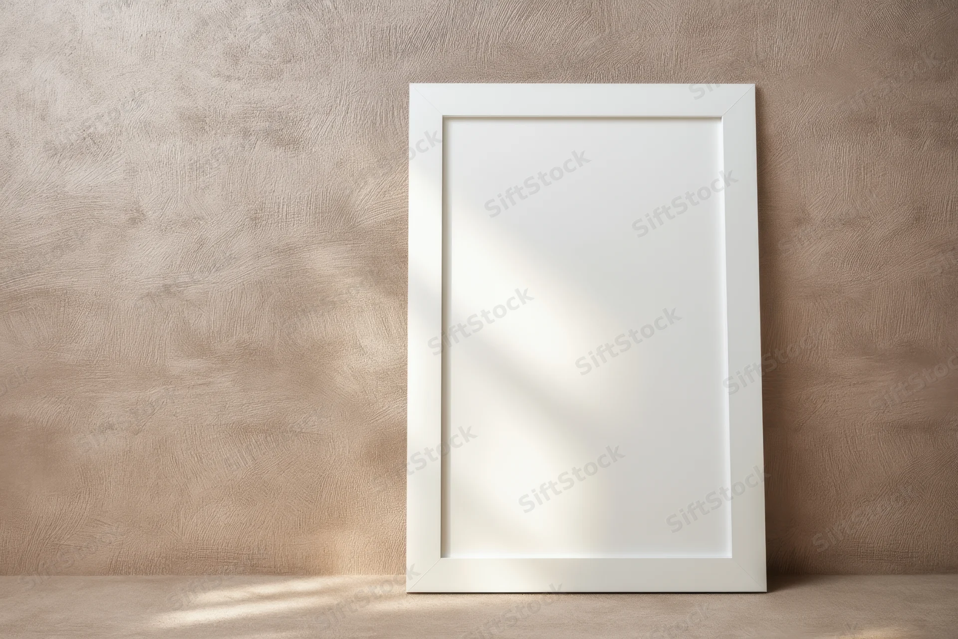 White frame leaning against textured taupe wall in minimalist interior