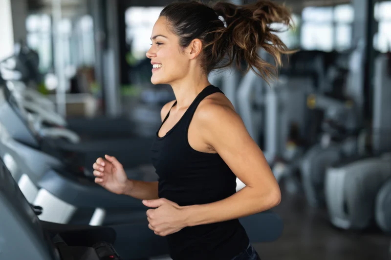 Woman running on treadmill in gym
