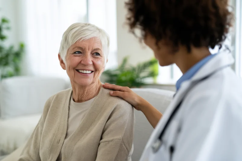 Senior woman smiling during a doctor's home visit consultation