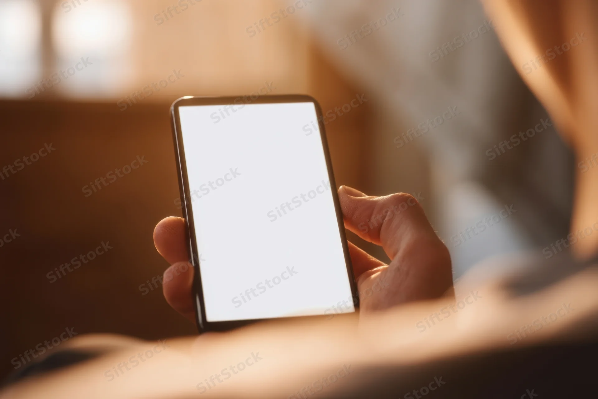 Hand holding smartphone with bright white screen in closeup view