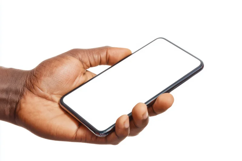 Hand holding a modern smartphone with blank screen against white background