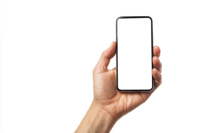 Hand holding smartphone with blank screen against white background