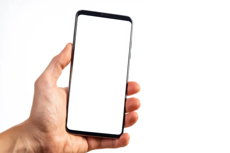 Hand holding a modern smartphone with blank white screen against white background