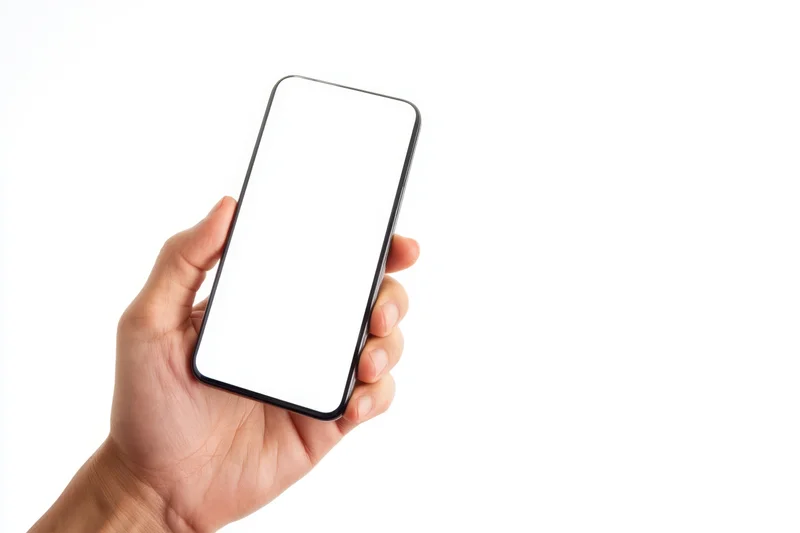 Hand holding smartphone with blank white screen against white background