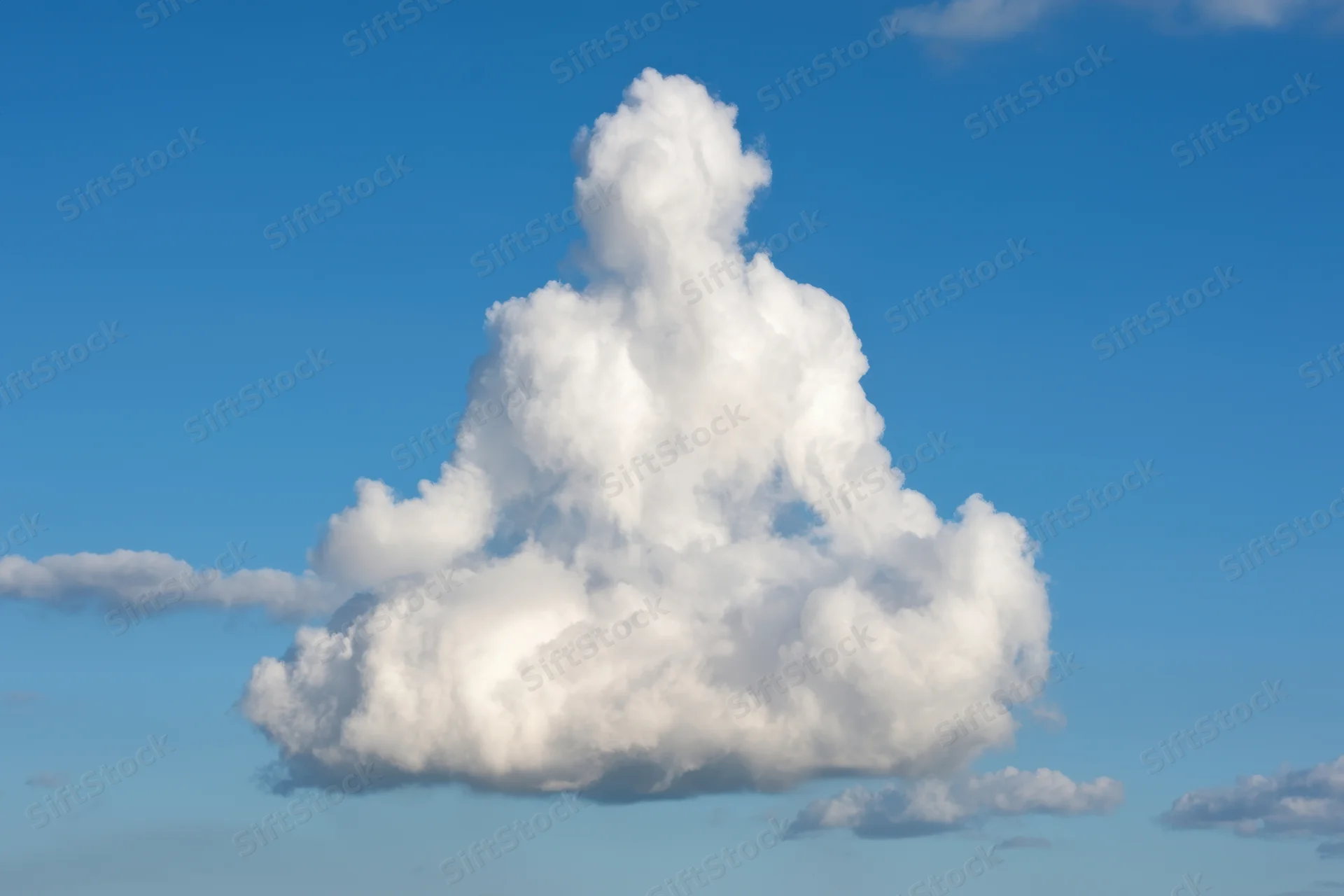 Large fluffy cloud shaped like a meditating figure against a clear blue sky