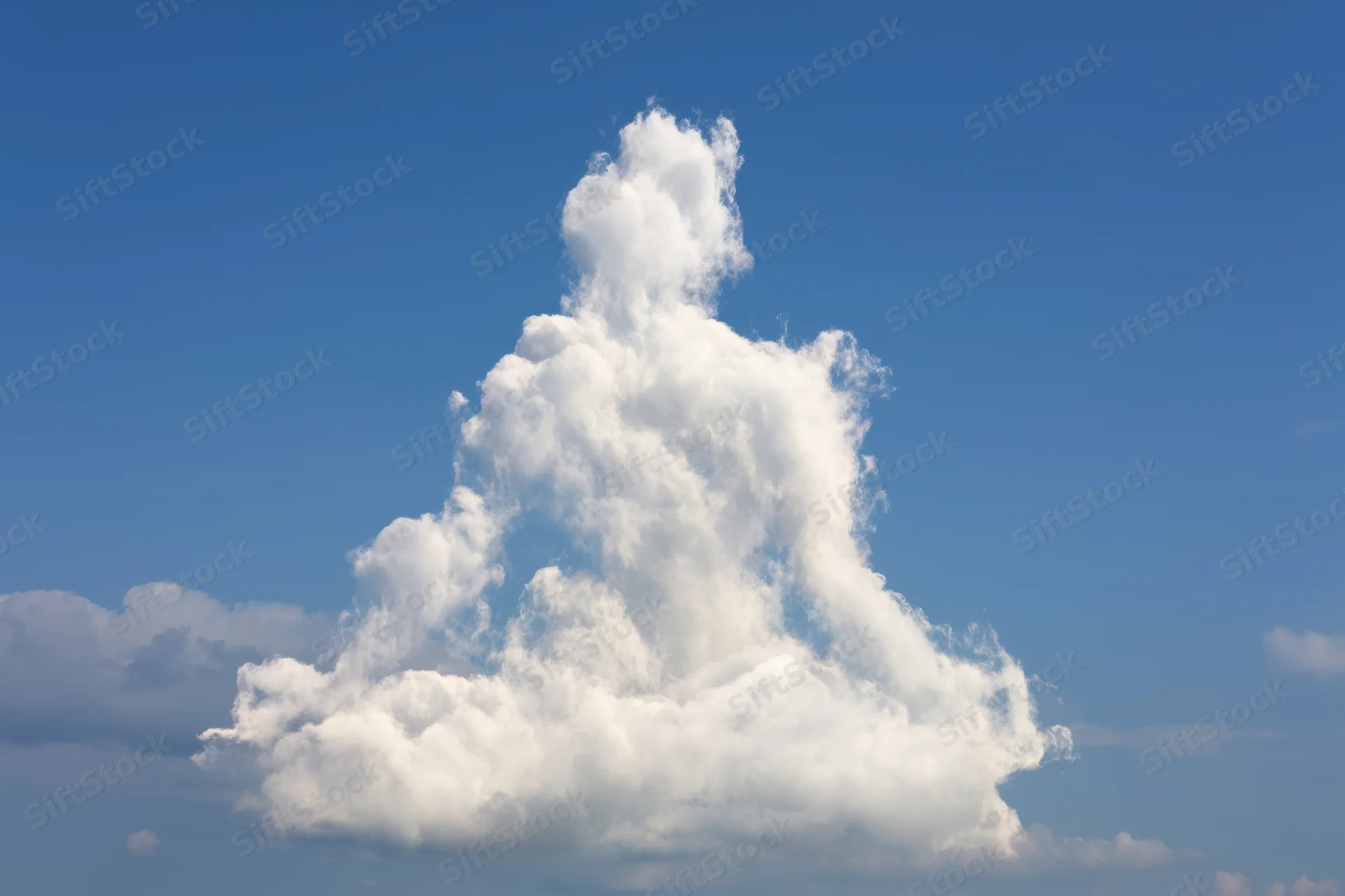 Large fluffy white cloud shaped like a meditating figure against clear blue sky
