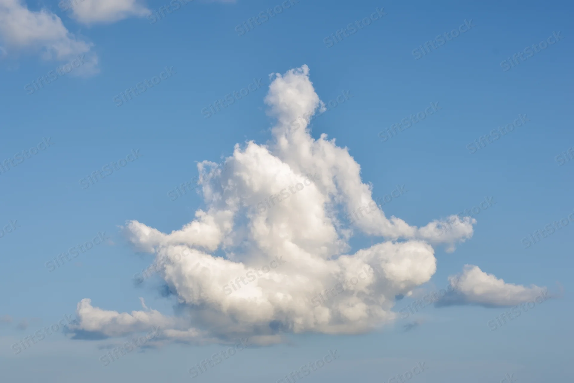 Large fluffy white cloud shaped like a meditating figure against a clear blue sky