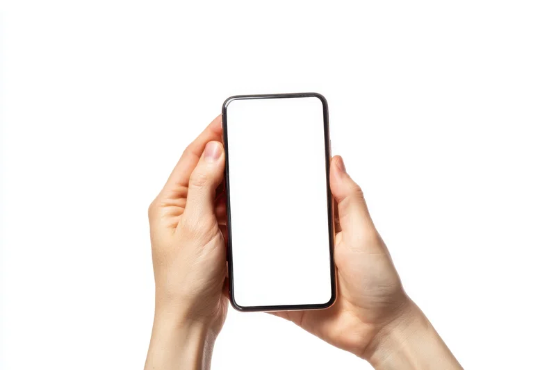 Hands holding a smartphone with a blank white screen against a white background