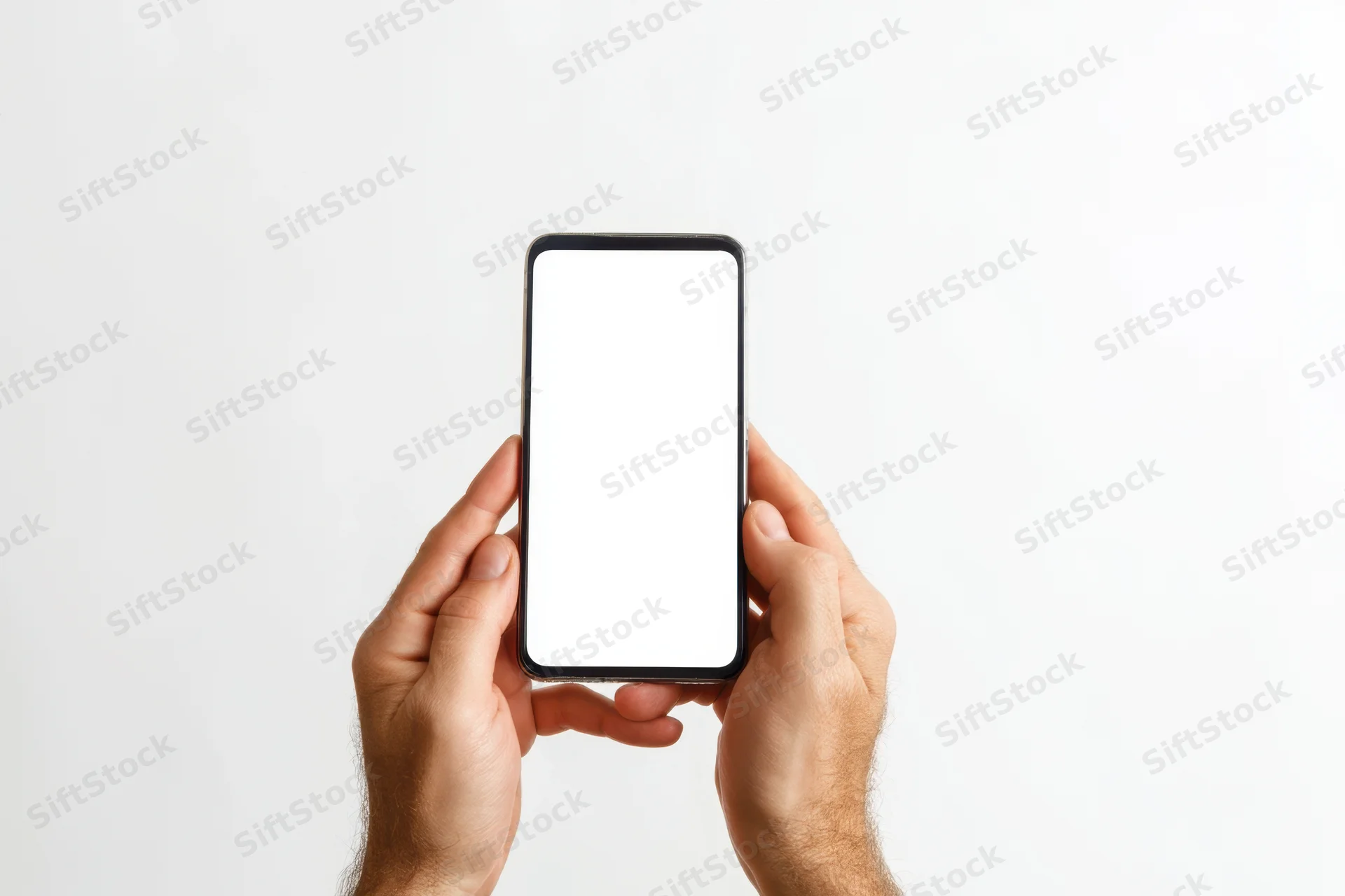 Hands holding smartphone with blank white screen against white background
